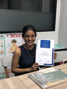 female holding a certificate